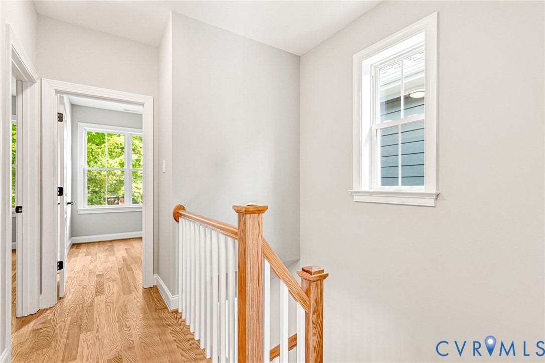 306 E 33rd Street, Swansboro West, Richmond, VA 23224 Hardwood flooring, painted walls, white trim, wood handrail, white balusters, and a double-hung window