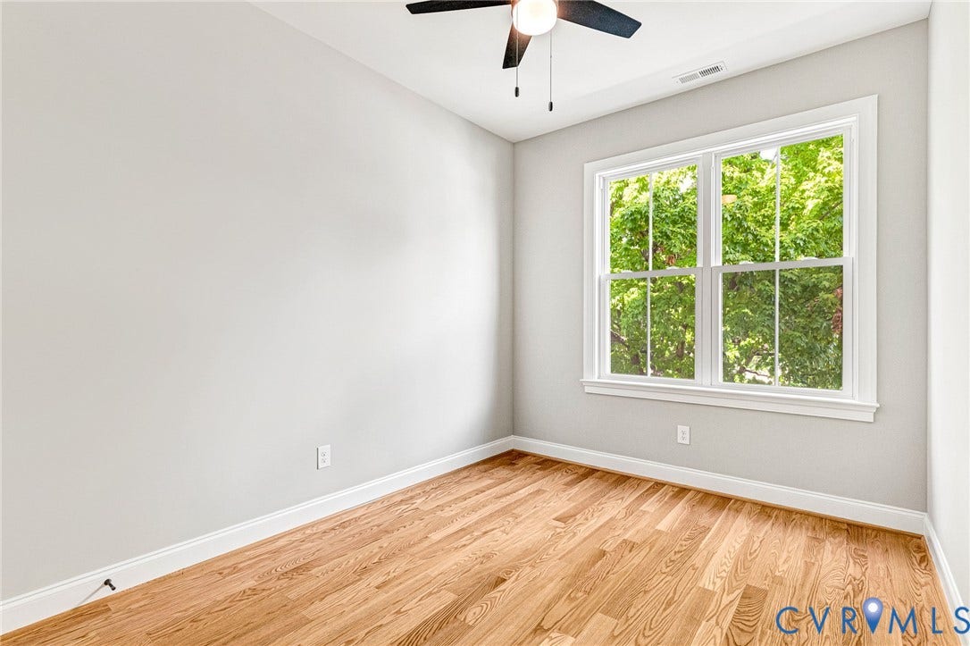 306 E 33rd Street, Swansboro West, Richmond, VA 23224 Hardwood flooring, painted walls, white trim, double-hung window, and a ceiling fan with integrated lighting