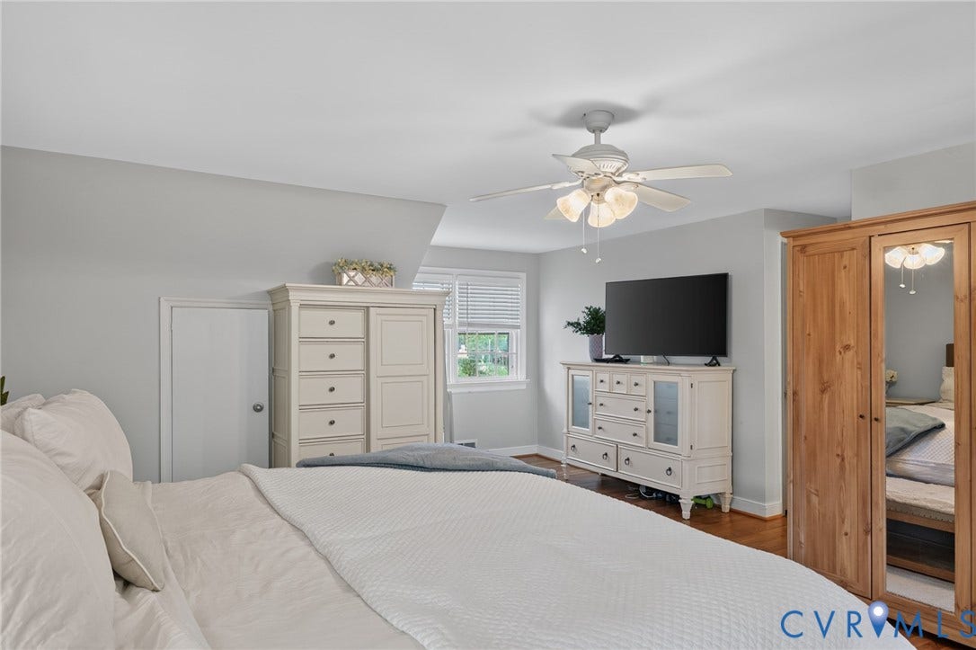 Hardwood-style flooring, a window with blinds, a ceiling fan with integrated lighting, and painted walls