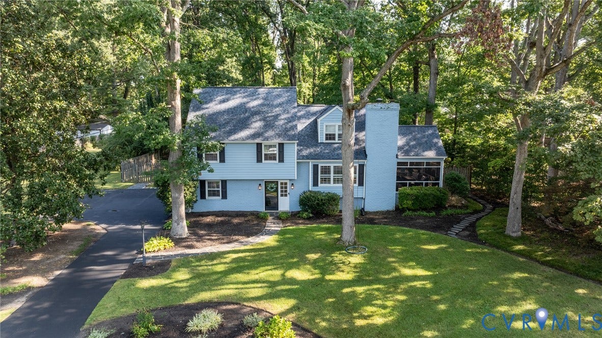 Two-story residence featuring light blue siding, black shutters, and an attached screened porch