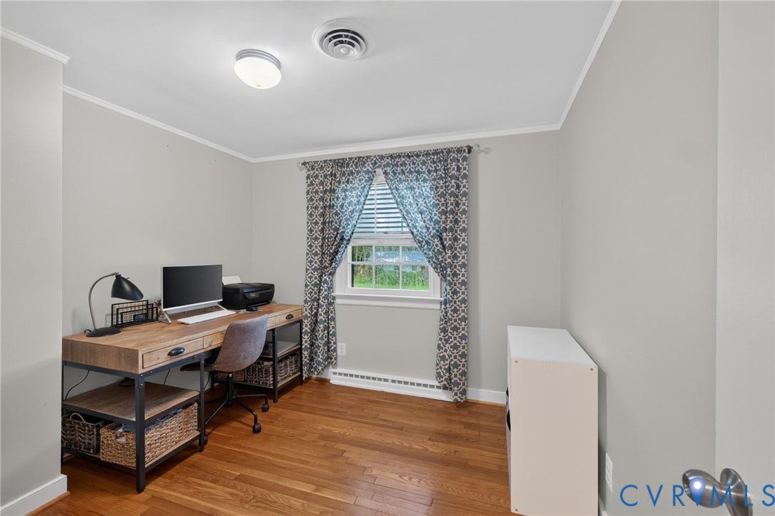 Hardwood flooring, light gray wall finish, window with horizontal blinds, and crown molding