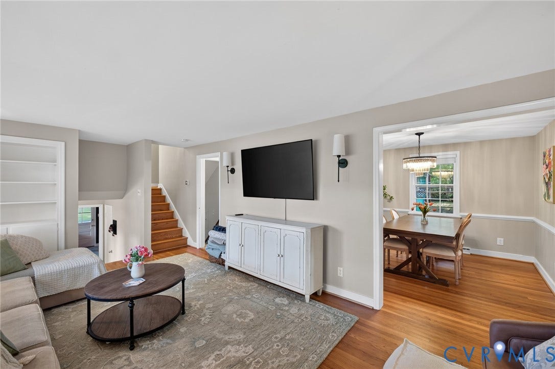 Built-in shelving, wood-finish flooring, and wall-mounted sconces