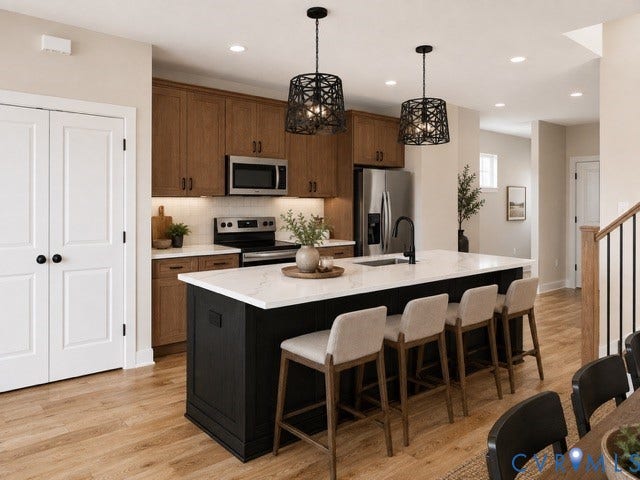 5416 Blueridge Avenue, Richmond, VA 23231 Kitchen featuring wood-finish flooring, a central island with white countertop, dark base cabinetry, and stainless steel appliances