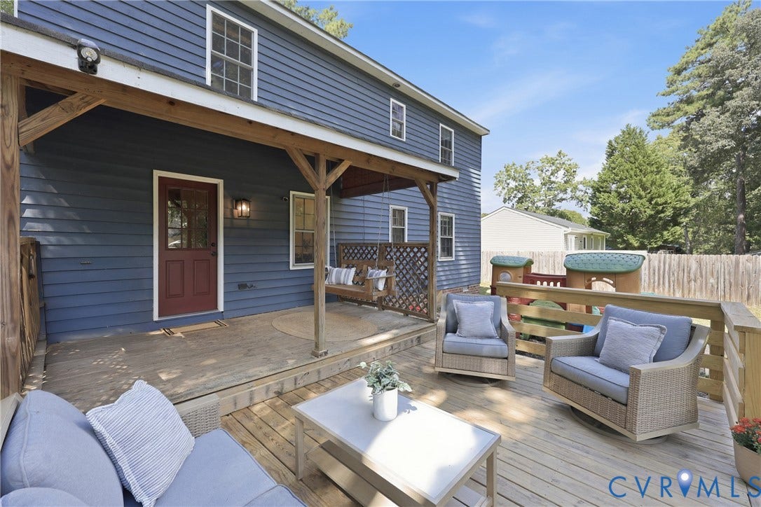 9349 Shiloh Drive, Chesterfield, VA 23237 Expansive wood deck with a covered porch featuring a porch swing