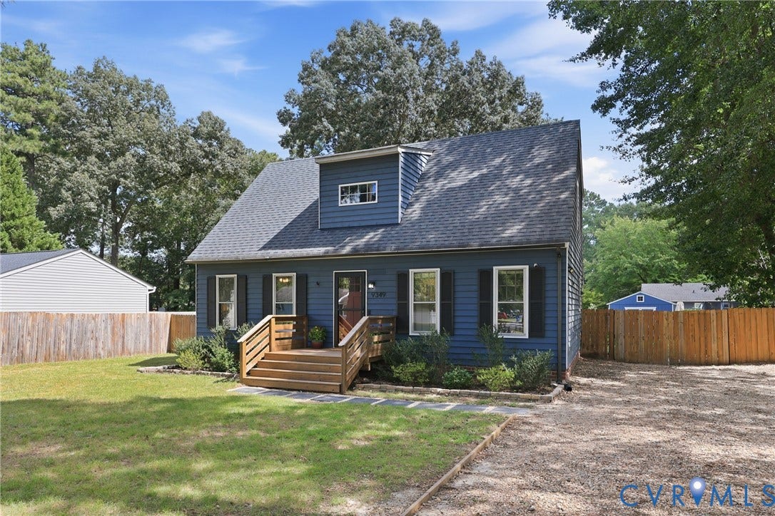 9349 Shiloh Drive, Chesterfield, VA 23237 Blue siding exterior with black shutters, dormer window, wood decking entry stairs, and a gravel driveway