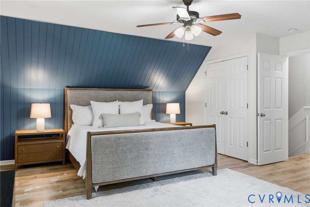 9349 Shiloh Drive, Chesterfield, VA 23237 Sloped ceiling with accent wall, wood-finish flooring, ceiling fan with light kit, and bi-fold closet doors