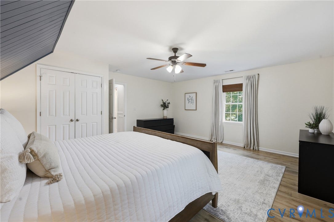 9349 Shiloh Drive, Chesterfield, VA 23237 Vaulted ceiling with wood paneling, wood-finish flooring, ceiling fan with light fixture, window with blinds, and white bi-fold closet doors
