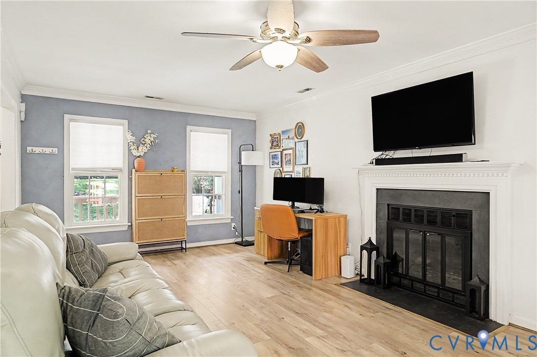 1506 Porters Mill Terrace, Smoketree South, Midlothian, VA 23114 Wood-finish flooring, ceiling fan with integrated lighting, fireplace with a black insert and white mantel, and multiple windows