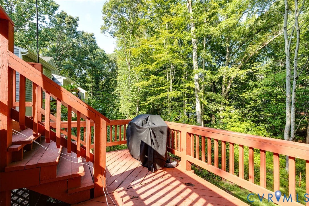 1506 Porters Mill Terrace, Smoketree South, Midlothian, VA 23114 Multi-level wood deck with wood railings, featuring a treed backdrop