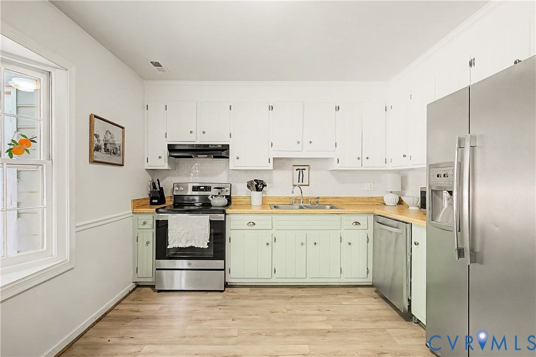 1506 Porters Mill Terrace, Smoketree South, Midlothian, VA 23114 Kitchen featuring wood-finish flooring, white upper cabinetry, light-toned lower cabinetry, stainless steel appliances, and a window with white trim