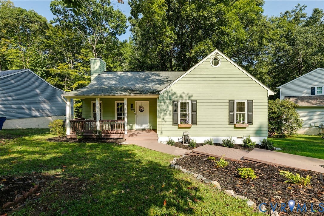 1506 Porters Mill Terrace, Smoketree South, Midlothian, VA 23114 Light green siding exterior with a covered front porch, dark shutters, a circular attic window, and an established front garden bed