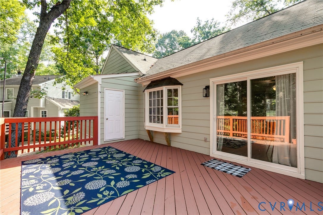 1506 Porters Mill Terrace, Smoketree South, Midlothian, VA 23114 Expansive exterior deck with red wood railing, light green siding, a bay window, and a sliding glass door