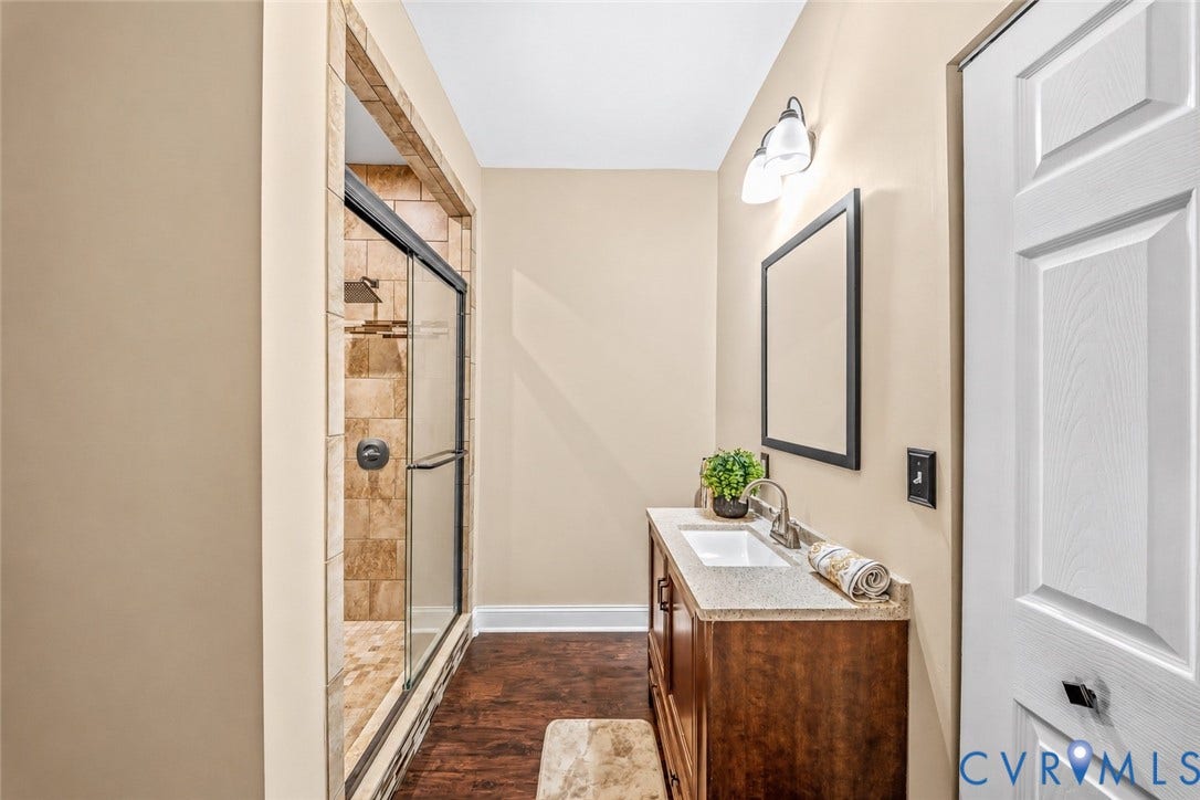 25014 Ferndale Road, Dinwiddie, VA 23803 Shower with a sliding glass door and stone-tiled walls