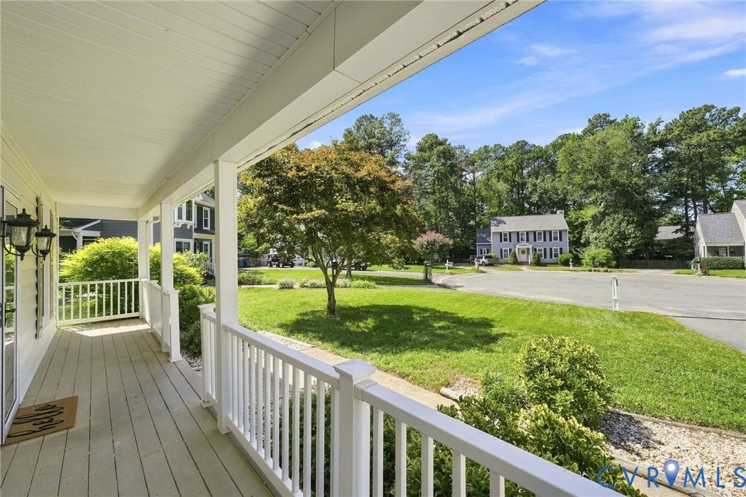 4509 Vienna Woods Place, Innsbrook, Henrico, VA 23060 Expansive covered front porch with white railing, wood-finish flooring, and dual sconce lighting