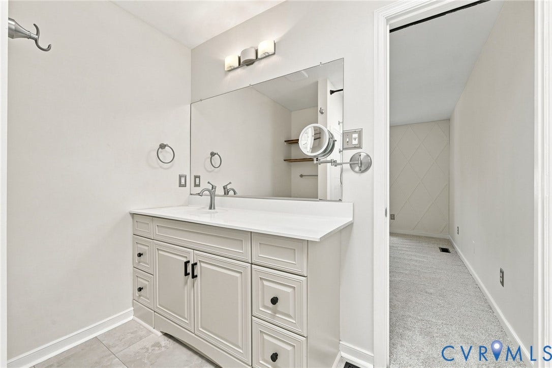 4509 Vienna Woods Place, Innsbrook, Henrico, VA 23060 Curved vanity with white countertop, chrome faucet, and rectangular mirror