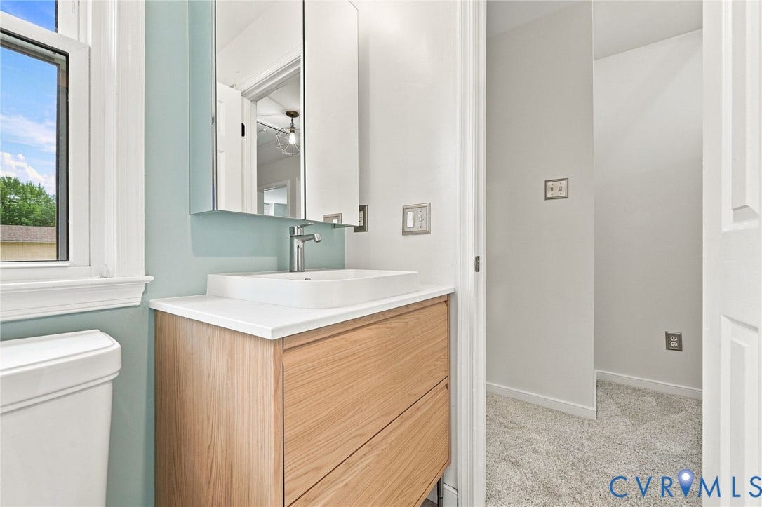 4509 Vienna Woods Place, Innsbrook, Henrico, VA 23060 Modern vanity with wood-finish cabinetry, white countertop, and vessel sink