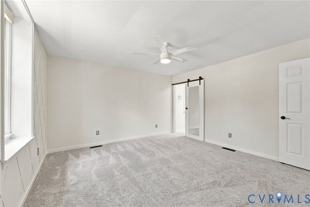 4509 Vienna Woods Place, Innsbrook, Henrico, VA 23060 White walls with an accent wall, wall-to-wall carpeting, ceiling fan with integrated lighting, and a barn door with a full-length mirror