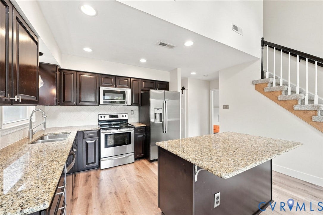 4509 Vienna Woods Place, Innsbrook, Henrico, VA 23060 Kitchen featuring wood-finish flooring, dark wood cabinetry, stainless steel appliances, and granite countertops