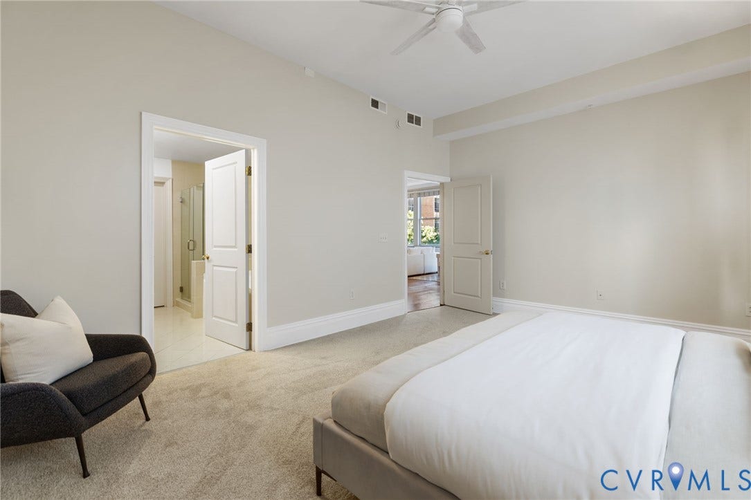 6 N 6th Street, #U5B, Downtown/Financial District, Richmond, VA 23219 Vaulted ceiling, ceiling fan, neutral carpet flooring, white trim details, and recessed baseboards