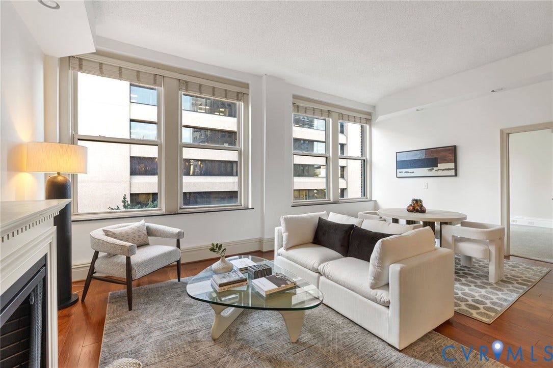 6 N 6th Street, #U5B, Downtown/Financial District, Richmond, VA 23219 Hardwood flooring, multiple large windows, recessed lighting, and a white fireplace mantel