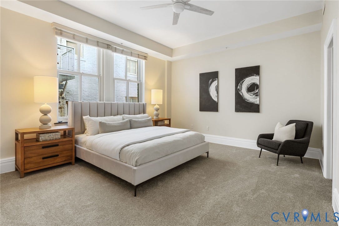 6 N 6th Street, #U5B, Downtown/Financial District, Richmond, VA 23219 Expansive room with neutral carpeting, large double-hung windows, and a ceiling fan