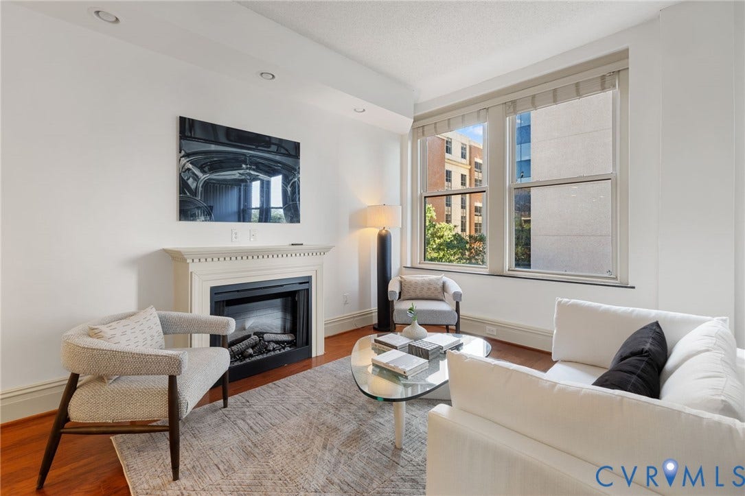 6 N 6th Street, #U5B, Downtown/Financial District, Richmond, VA 23219 Living area featuring a fireplace with a decorative mantel, recessed lighting, wood-finish flooring, and expansive windows
