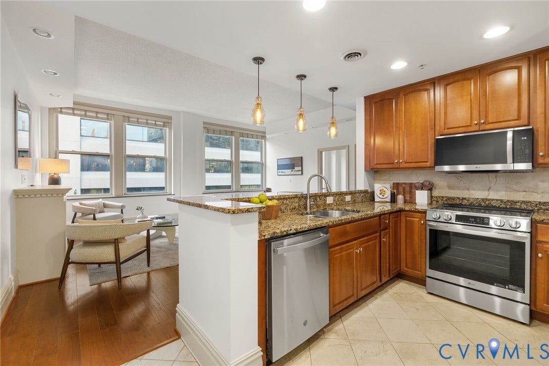 6 N 6th Street, #U5B, Downtown/Financial District, Richmond, VA 23219 Kitchen featuring granite countertops, wood cabinetry, stainless steel appliances, and pendant lighting
