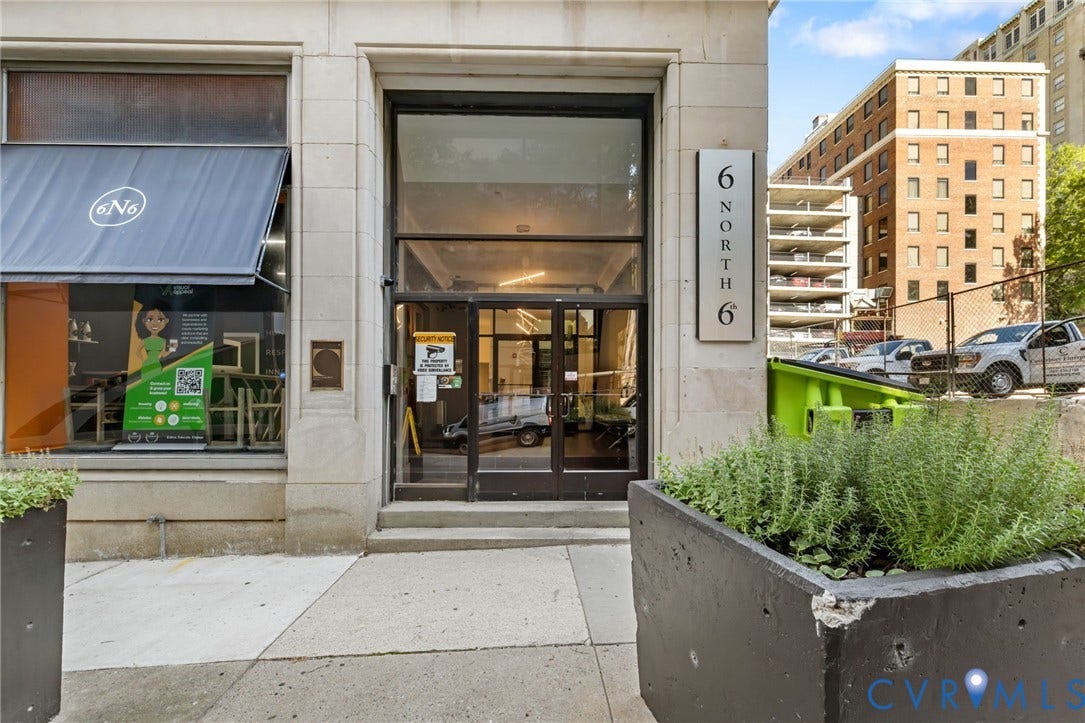 6 N 6th Street, #U5B, Downtown/Financial District, Richmond, VA 23219 Street-level building entrance with large glass doors and an overhead transom