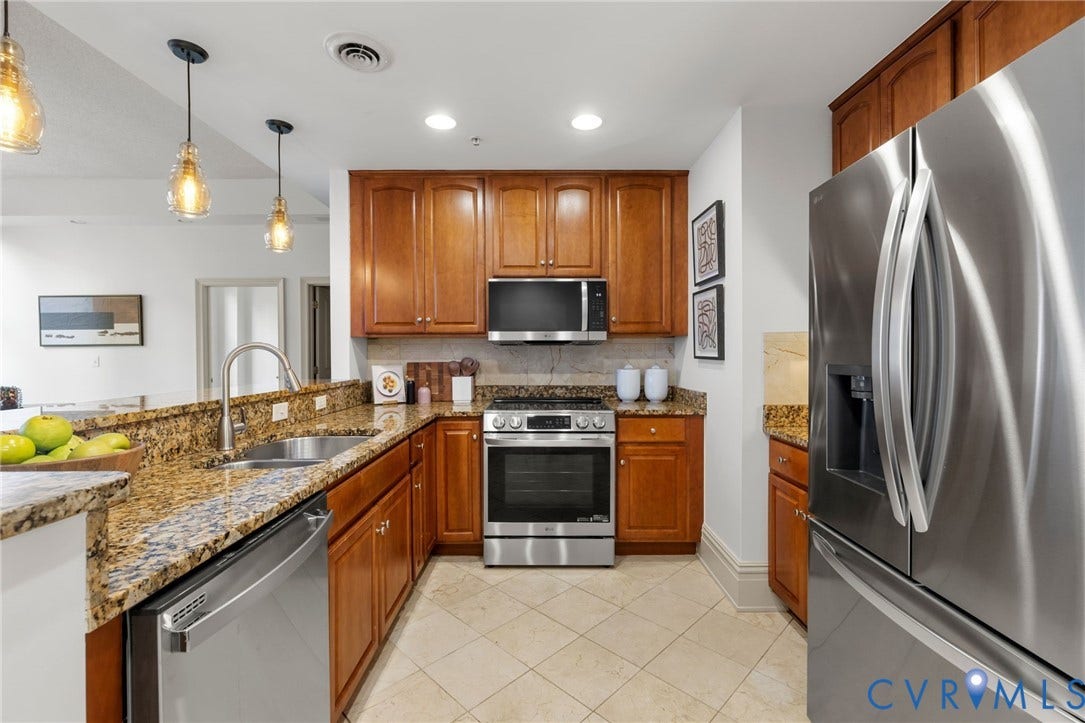 6 N 6th Street, #U5B, Downtown/Financial District, Richmond, VA 23219 Kitchen featuring wood cabinetry, stainless steel appliances, granite countertops, and tile flooring