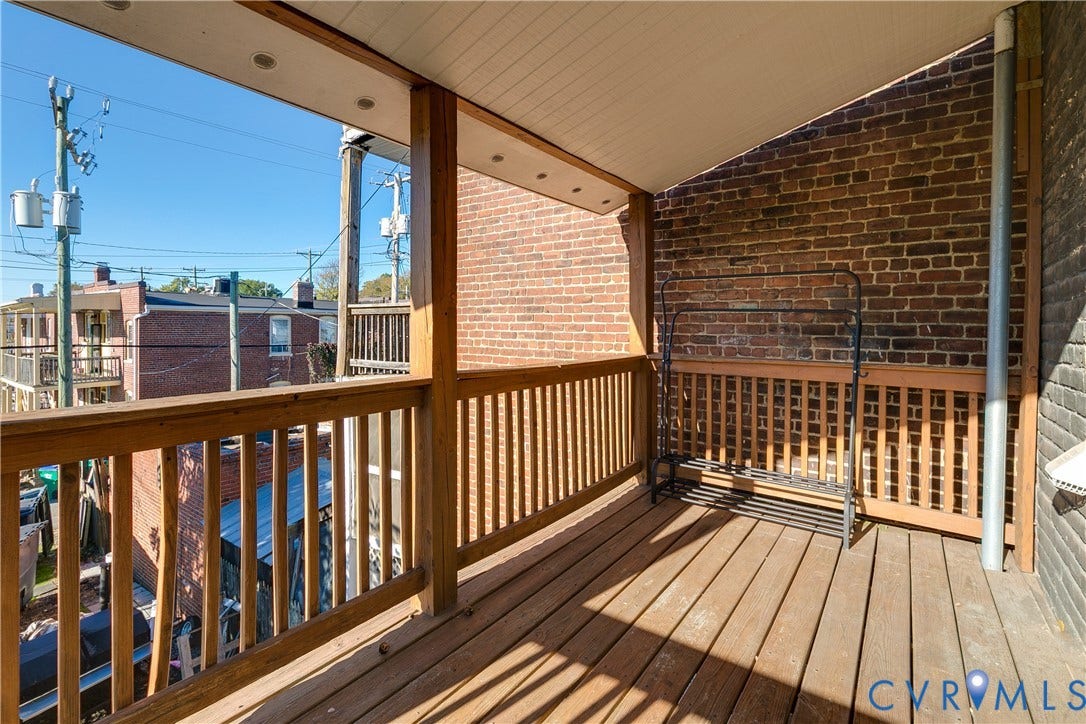 2523 W Main Street, The Fan, Richmond, VA 23220 Exterior balcony featuring wood decking, wood railings, and a brick wall