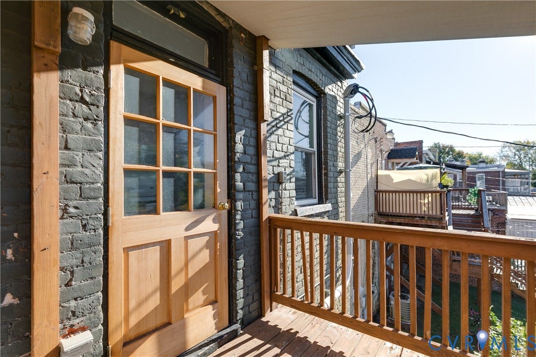 2523 W Main Street, The Fan, Richmond, VA 23220 Exterior wood-finish door with glass panes, leading to a wood-finish deck with railing