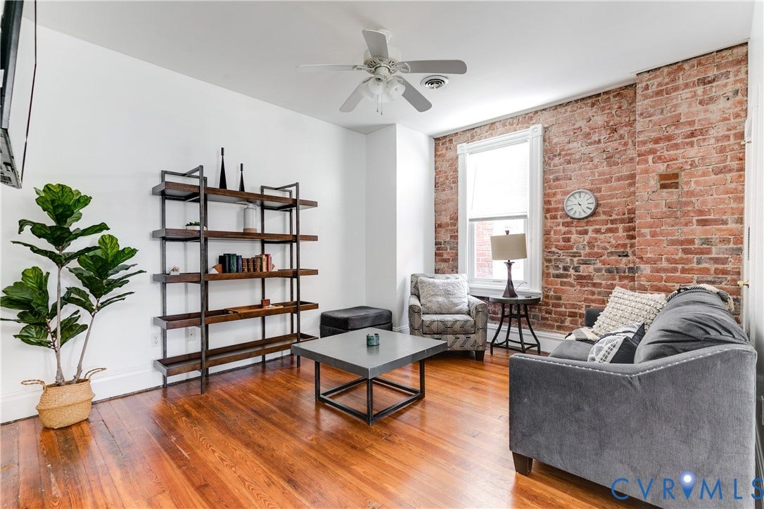 2523 W Main Street, The Fan, Richmond, VA 23220 Exposed brick wall, wood-finish flooring, white ceiling fan, and built-in shelving unit