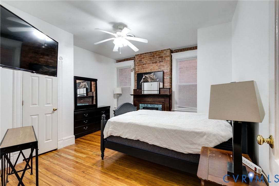 2523 W Main Street, The Fan, Richmond, VA 23220 Hardwood flooring complemented by a brick accent wall and a built-in fireplace