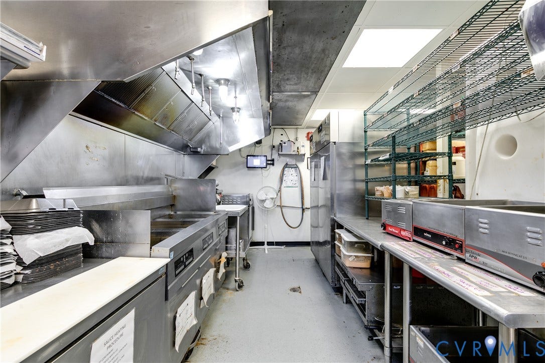 2523 W Main Street, The Fan, Richmond, VA 23220 Stainless steel commercial-grade kitchen equipment, extensive built-in shelving, and integrated overhead lighting