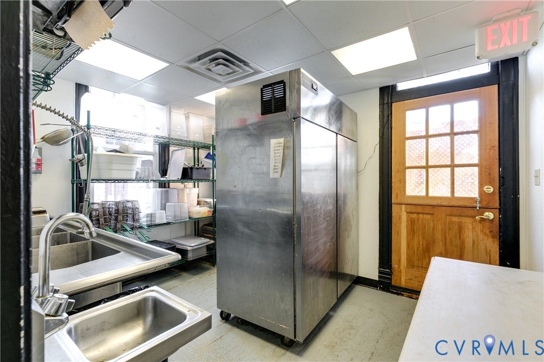 2523 W Main Street, The Fan, Richmond, VA 23220 Commercial-grade double stainless steel sink, industrial shelving, stainless steel refrigerator, and recessed lighting