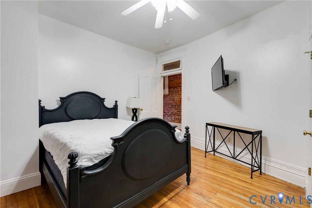 2523 W Main Street, The Fan, Richmond, VA 23220 Hardwood flooring, high ceilings, ceiling fan, white trim, and a wall-mounted television