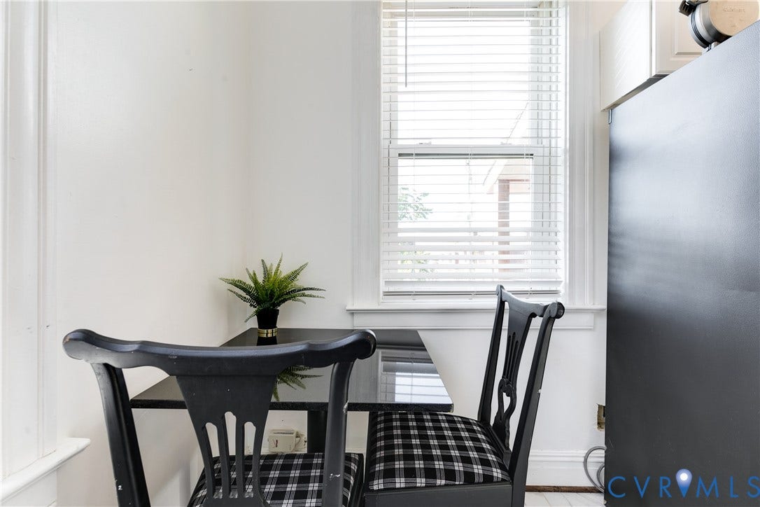 2523 W Main Street, The Fan, Richmond, VA 23220 White walls with window, featuring a black table and chairs