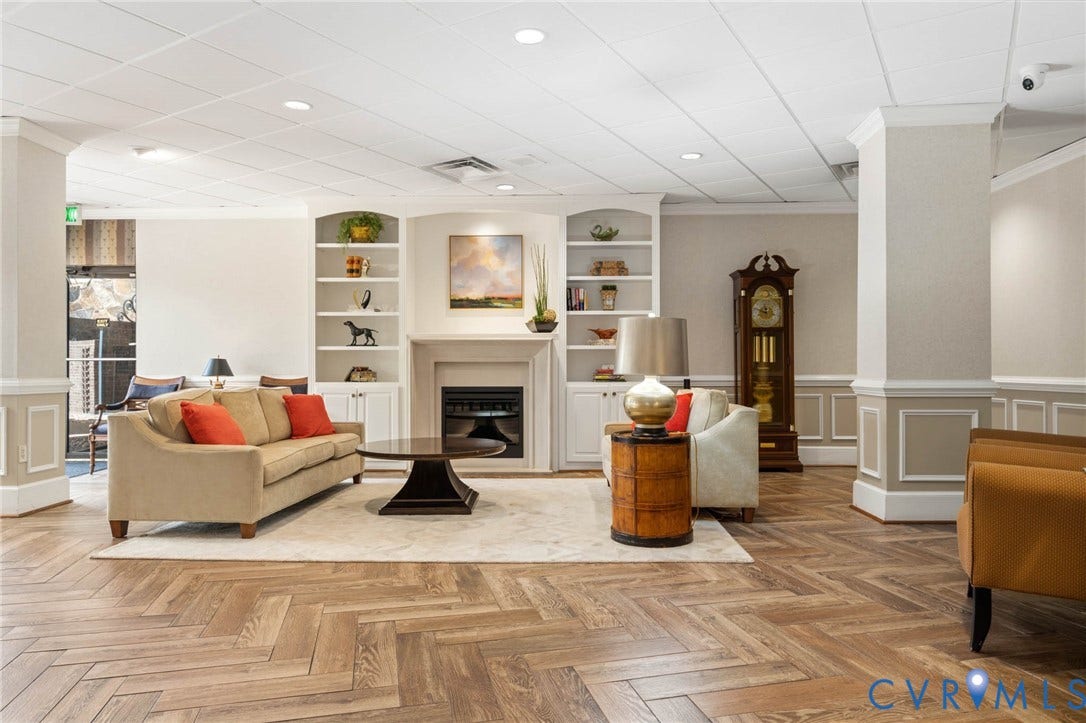 2956 Hathaway Road, #U407, Richmond, VA 23225 Herringbone wood-finish flooring, built-in shelving, decorative fireplace, recessed lighting, and crown molding