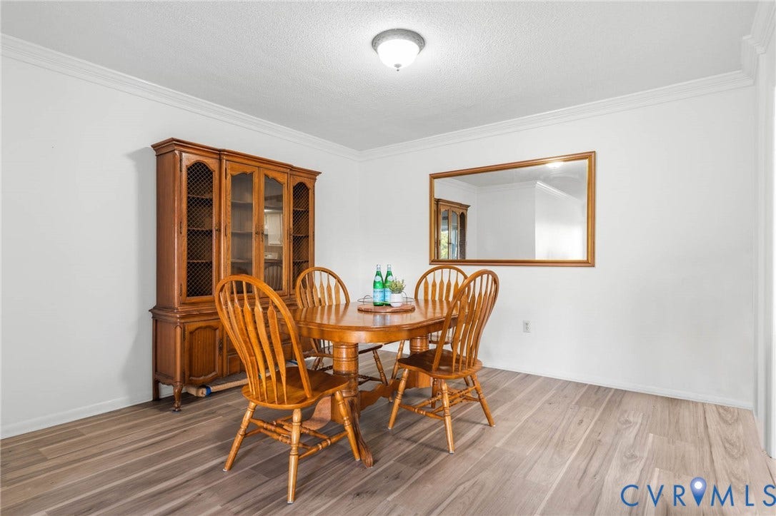 2956 Hathaway Road, #U407, Richmond, VA 23225 Wood-finish flooring, white painted walls, and crown molding