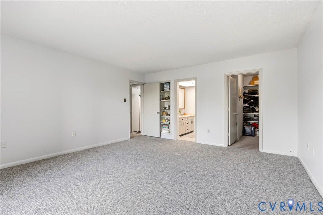 2956 Hathaway Road, #U407, Richmond, VA 23225 Spacious room featuring light gray carpeting, neutral white wall finishes, and a bright overhead light fixture