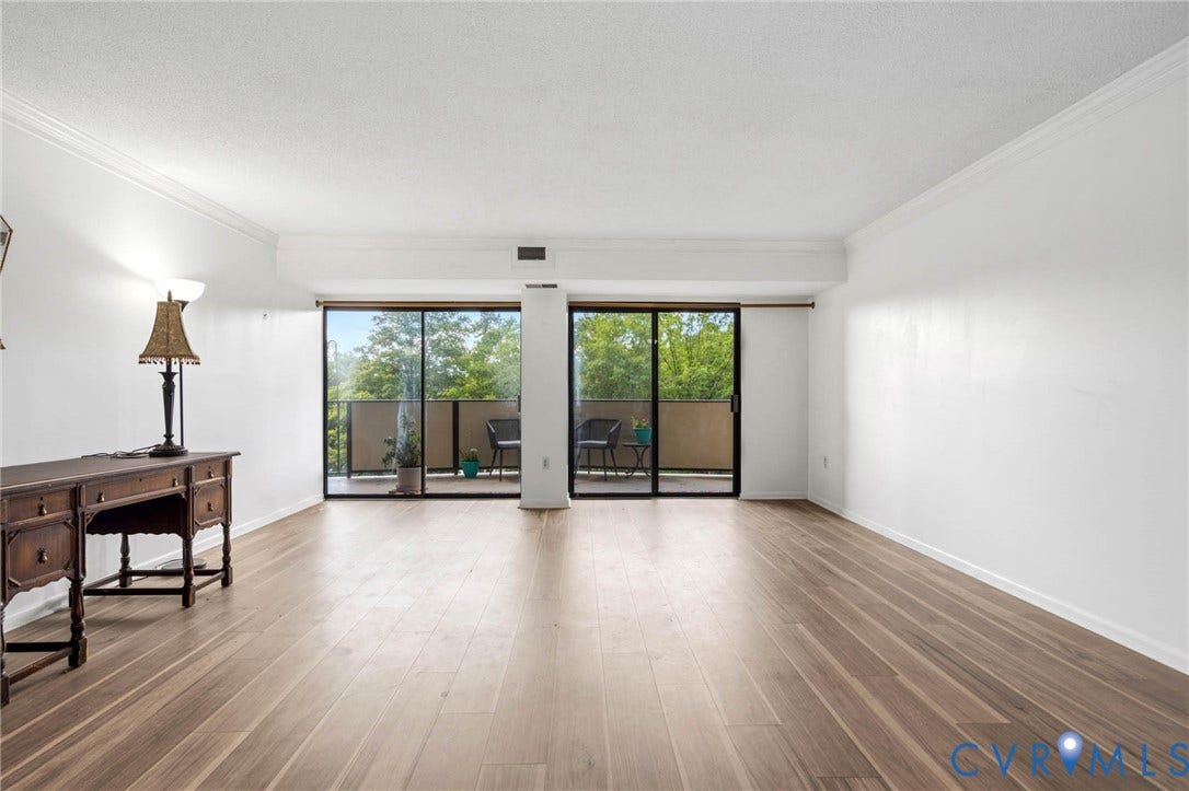 2956 Hathaway Road, #U407, Richmond, VA 23225 Wood-finish flooring, crown molding, and a balcony with sliding glass doors
