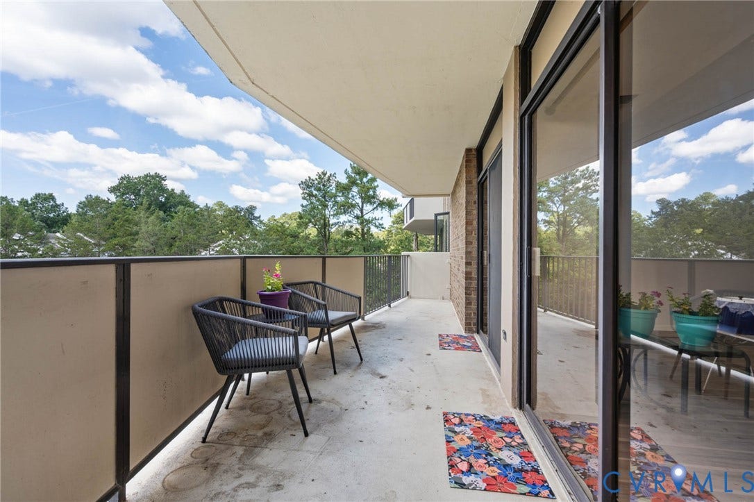 2956 Hathaway Road, #U407, Richmond, VA 23225 Expansive balcony with a concrete surface, metal railings, and a brick exterior wall