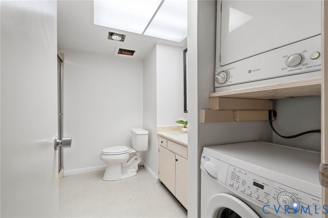 2956 Hathaway Road, #U407, Richmond, VA 23225 Bathroom featuring a toilet, vanity with countertop, and integrated stacked washer and dryer