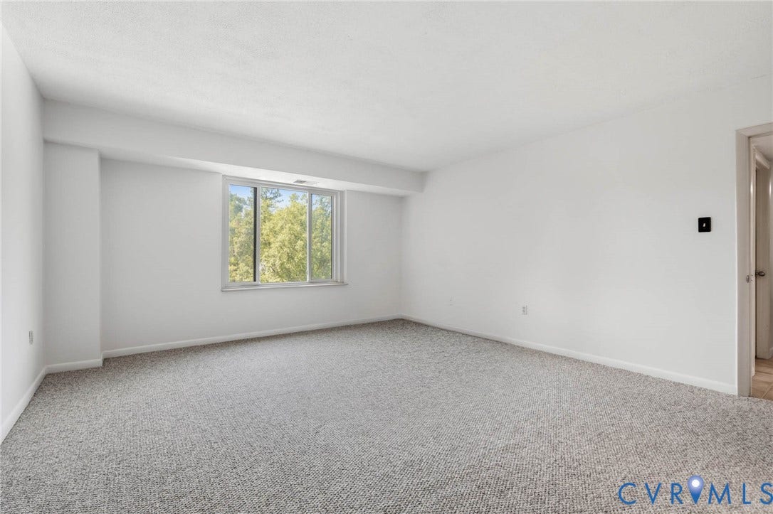 2956 Hathaway Road, #U407, Richmond, VA 23225 Light gray carpeting throughout, white painted walls, and a large window