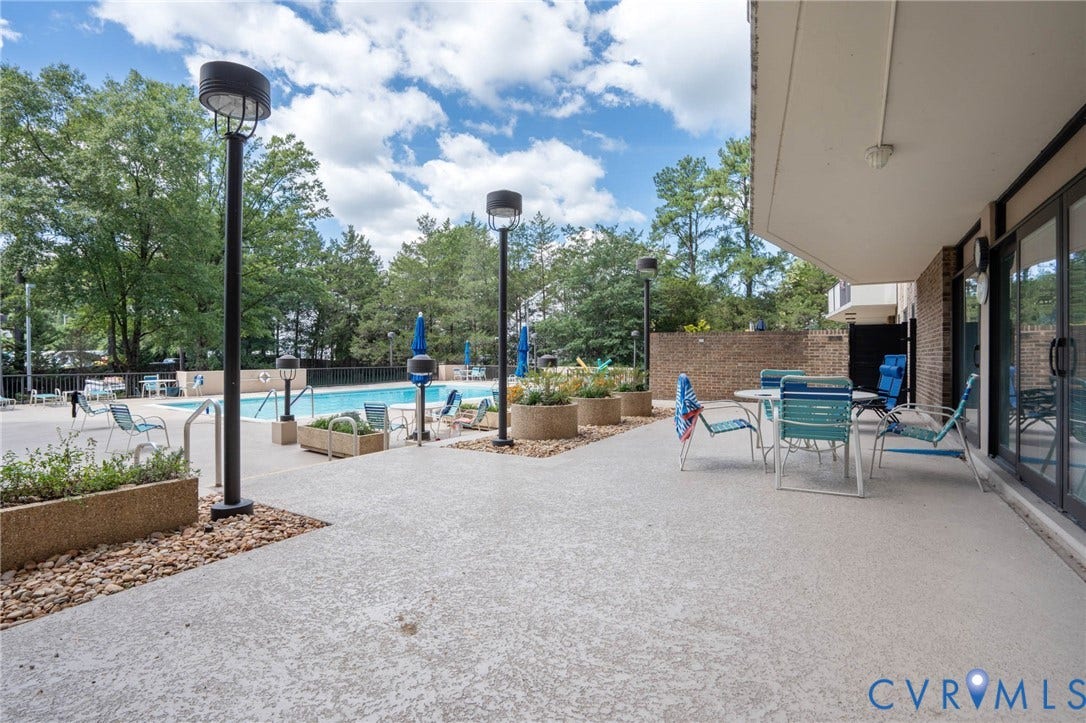 2956 Hathaway Road, #U407, Richmond, VA 23225 Spacious outdoor patio with direct access to the swimming pool, surrounded by mature trees