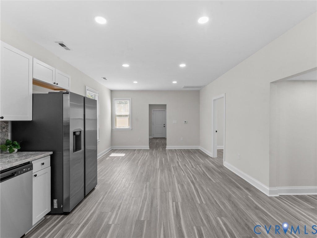 3059 Decatur Street, Richmond, VA 23224 Open-concept living space featuring dining area and living room, new flooring, recessed lighting, and white cabinetry