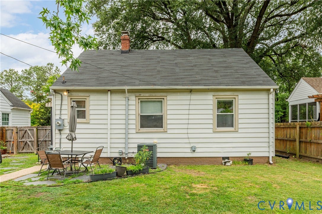 613 Rothesay Road, City Stadium, Richmond, VA 23221 White siding exterior with a shingle roof, brick chimney, and a stone patio