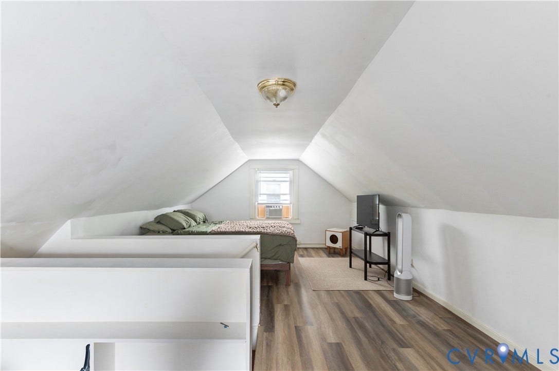613 Rothesay Road, City Stadium, Richmond, VA 23221 Sloped ceiling room featuring wood-finish flooring, a window with an air conditioning unit, and a flush mount light fixture