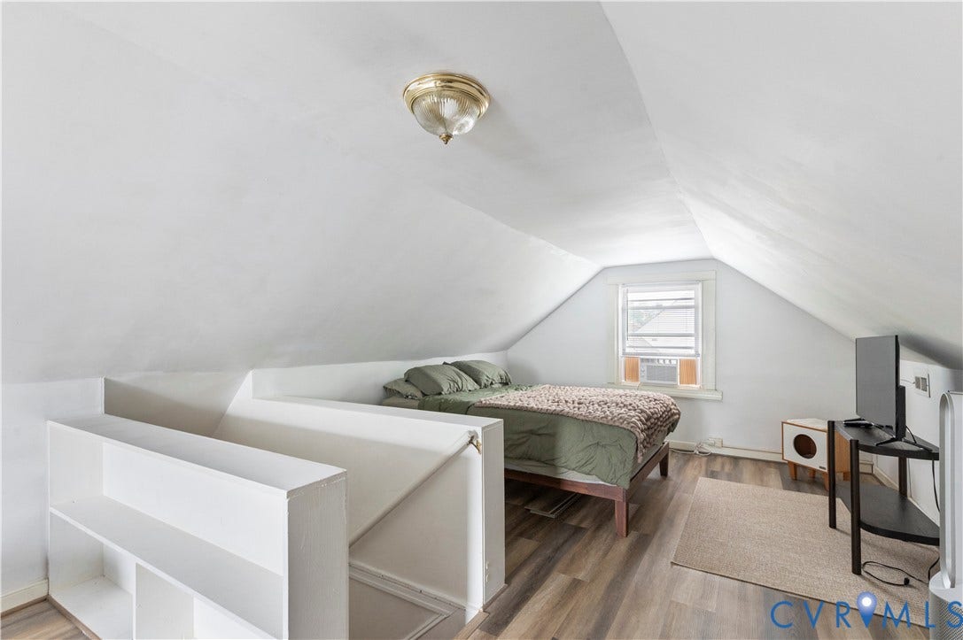 613 Rothesay Road, City Stadium, Richmond, VA 23221 Attic space with sloped ceilings, a single window, overhead lighting, and wood-finish flooring