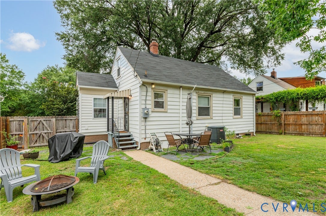 613 Rothesay Road, City Stadium, Richmond, VA 23221 Rear exterior featuring white horizontal siding, a stone patio area, and a dark shingle roof